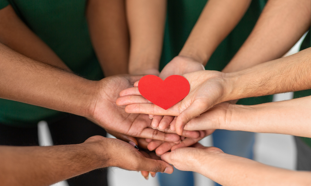 Hands holding a paper heart